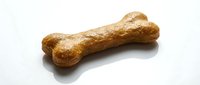 Dog treat bone shaped biscuit with textured surface on white background, suitable for pet food packaging and veterinary marketing materials.