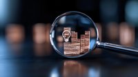 Financial growth chart viewed through magnifying glass on dark background showing business analytics and market research data visualization for investment strategy.