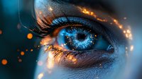 Macro shot of luminous blue eye with magical glowing sparkles and light effects around eyelashes, creating mystical and enchanting atmosphere.