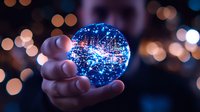 Glowing crystal ball with magical blue light effects and sparkles held in hand against blurred bokeh background, creating mystical atmosphere.