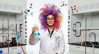Female scientist with colorful purple hair holding test tube in chemistry laboratory with molecular structure background for educational content.