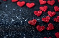 Glittering red heart confetti scattered on dark background, perfect for Valentine's Day, wedding, or romantic celebration designs.