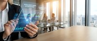Professional businesswoman using transparent tablet with intelligent data analytics interface in modern corporate office environment for digital transformation.