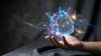Person's hand holding glowing digital network structure with interconnected nodes and lines in blue, purple, and gold tones, representing technology, data connection, and innovation concepts.