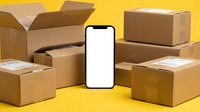 Smartphone with blank white screen surrounded by cardboard shipping boxes on yellow background for delivery app mockup and e-commerce logistics concepts.