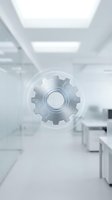 Transparent gear icon floating in modern white office corridor representing business automation, workflow optimization and digital transformation solutions.
