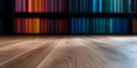 Wooden table surface with blurred colorful background showing spectrum of warm and cool colors on shelves, creating atmospheric mood for product display.