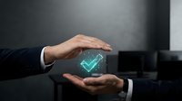 Businessman hands protecting glowing digital checkmark symbol representing security, approval and quality assurance in modern office environment.
