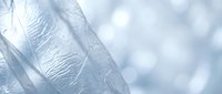 Delicate white feather close-up with soft bokeh background creating peaceful natural texture for wellness and spa design projects.