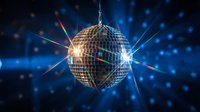 Sparkling disco ball with colorful light rays and bokeh effects on dark blue background for party and nightclub entertainment events.