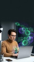 Young Caucasian male programmer working on laptop with holographic digital interface gears and data visualization in modern office workspace.