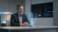 Middle-aged Caucasian businessman in suit interacting with holographic projection at modern office desk. Futuristic technology concept for presentations.