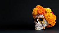 Decorated sugar skull with bright orange and yellow marigold flowers on black background, traditional Day of Dead celebration symbol with detailed ornaments.