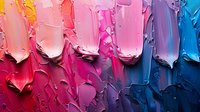 Vibrant paint smears transition from warm coral and pink to cool purple and blue tones, creating textured abstract strokes with thick impasto technique on dark surface.