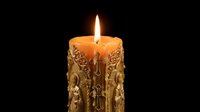 Ornate golden candle with intricate baroque patterns burning bright flame against black background for luxury home decor and romantic ambiance.