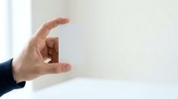 Adult male hand with light skin tone gesturing small size or measurement against neutral background, suitable for business, education, and instructional content.