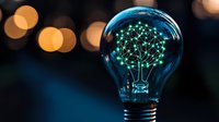 Glowing neural network shaped like light bulb filament with connected dots and lines on dark background with bokeh lights, symbolizing artificial intelligence innovation.