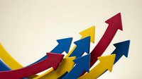 Colorful upward trending arrows in red, blue and yellow showing business growth, success and positive financial performance on neutral background.
