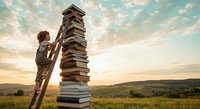 Young boy climbing wooden ladder to reach tall stack of books in golden sunset field representing education growth and learning achievement goals.