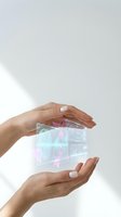Woman holding holographic digital interface with fingerprint biometric security technology and data visualization elements.