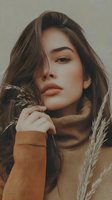 Young woman in cozy turtleneck sweater with pampas grass creating warm autumn mood portrait with natural lighting and soft tones for lifestyle content.