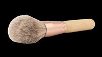 Makeup brush with natural bristles, rose gold ferrule, and wooden handle isolated on transparent background. Ready for beauty product design, tutorials, and print-on-demand applications.