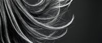 Flowing blonde hair strands in motion against dark background showcasing natural texture and movement for beauty and haircare concepts.