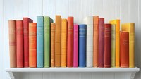 Row of colorful vintage hardcover books standing on white wooden shelf against white beadboard wall, showing spines in various pastel and bright shades.