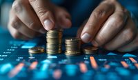 Male hands stacking gold coins on financial chart background, demonstrating investment growth and money management concept in blue toned lighting.