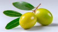 Fresh green olives with leaves on light background, close up view showing natural texture and shine. For food, cooking, and healthy lifestyle concepts.