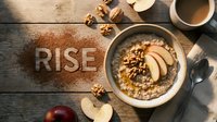 Warm oatmeal bowl with apple slices, walnuts, and honey on rustic wood, with RISE spelled in cinnamon powder for morning motivation.
