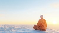 Buddhist monk in orange robe meditating on mountain peak at sunrise, sitting in lotus position above clouds, spiritual enlightenment concept for wellness and mindfulness.