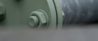 Industrial machinery bolt and nut connection with shallow depth of field for manufacturing and engineering applications.