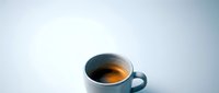 White ceramic coffee cup with fresh espresso on clean minimalist background for cafe branding and morning beverage concepts.
