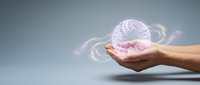 Hand holding glowing purple wireframe sphere with digital particles and light effects against gray background for technology and innovation concepts.