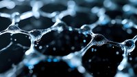Macro photography of water droplets forming delicate interconnected web patterns with light reflections against dark background, creating abstract network structure.