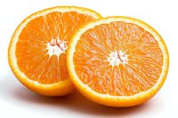 Fresh juicy orange fruit cut in half showing detailed pulp and segments on white background, bright citrus close up view for healthy eating concept.