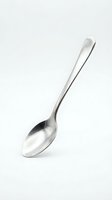 Stainless steel spoon isolated on white background for kitchen utensil design and culinary projects.