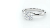 Classic solitaire diamond engagement ring with brilliant cut stone on white gold band isolated on white background for jewelry design and wedding concepts.