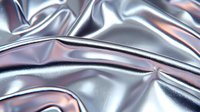 Metallic silver fabric with rose gold reflections creates flowing waves and folds, showing luxurious textile surface with dramatic light effects and shadows.