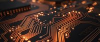 Close-up macro view of orange illuminated circuit board traces and electronic pathways with warm bokeh lighting effects for technology concepts.