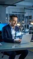 Middle-aged Caucasian businessman working on laptop with digital file icons in modern office at night for technology and data management concepts.
