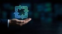 Businessman hand holding glowing neon recycling symbol with arrows on dark background, representing sustainability, circular economy, and environmental responsibility for corporate green initiatives.