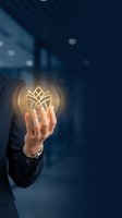 Businessman hand holding glowing golden lotus flower symbol representing wellness, mindfulness and spiritual growth in corporate environment.
