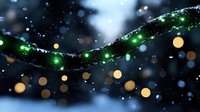 Glowing green string lights covered in snow against dark background with golden bokeh lights creating magical winter holiday atmosphere.