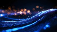 Glowing blue wave with sparkles and bokeh lights on dark background creates magical atmosphere for technology and innovation concepts.