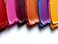 Colorful lipstick smears showing texture and shine of cosmetic products arranged in row on white background, makeup swatches demonstrating vibrant shades.
