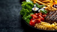 Colorful food platter with grilled steak, fusilli pasta, cherry tomatoes, broccoli, and sushi rolls on dark background. Restaurant quality presentation for menu design.