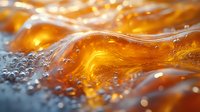 Macro shot of golden liquid with bubbles and waves creating dynamic texture and light effects. Amber fluid with ripples and air pockets in motion.