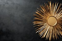 Golden sunburst mirror with radiating metallic rays on dark textured wall, luxury home decor accent piece for modern interior design and wall decoration.